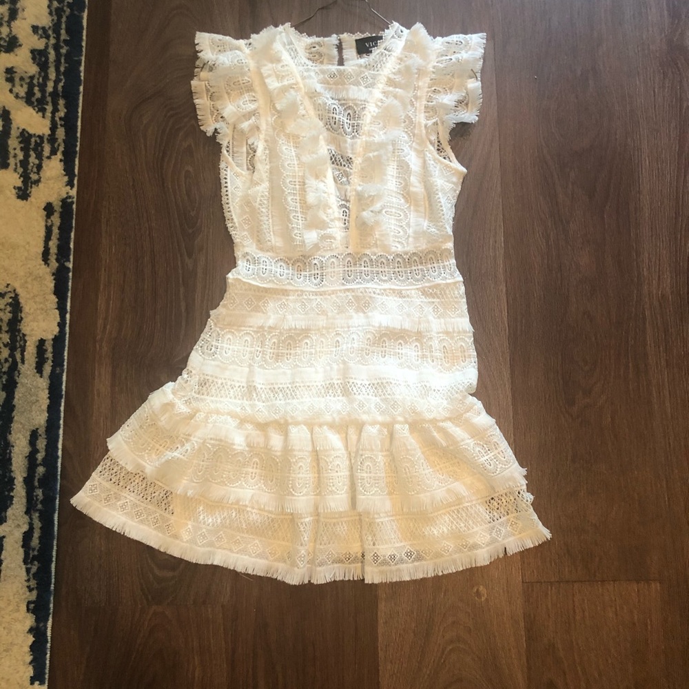 White dress with ruffles and open back detailing